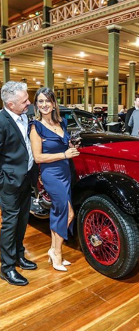 Guests with a red vintage tourer at Motorclassica